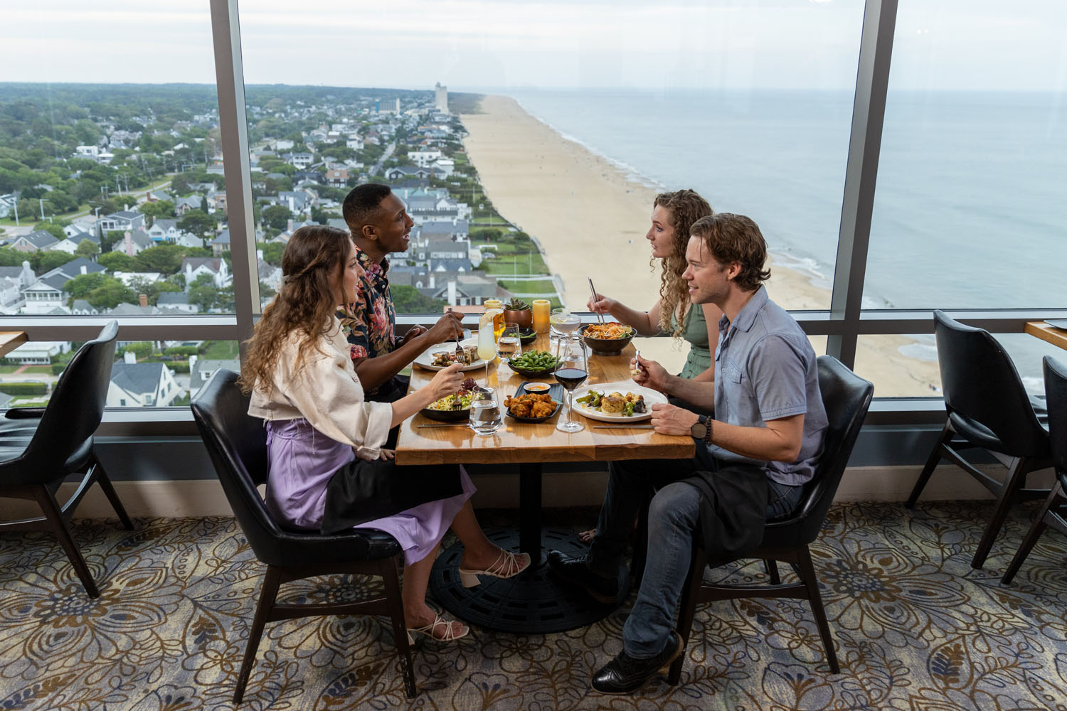A group of people eating a meal at Orion's Roof
