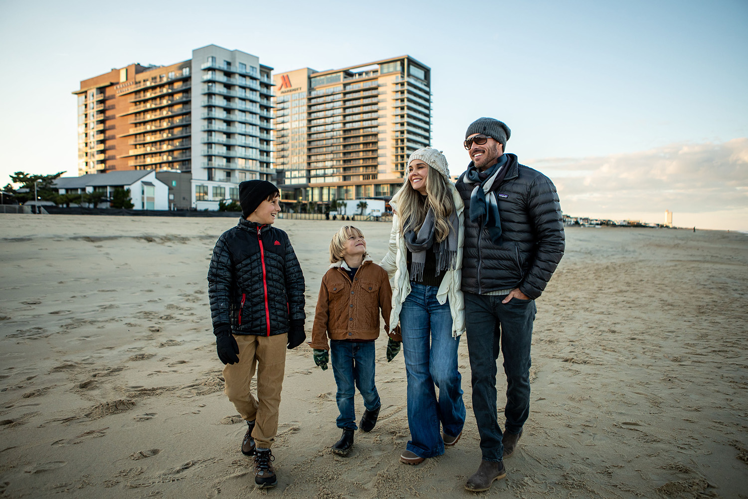 A family walking on the beach at dusk