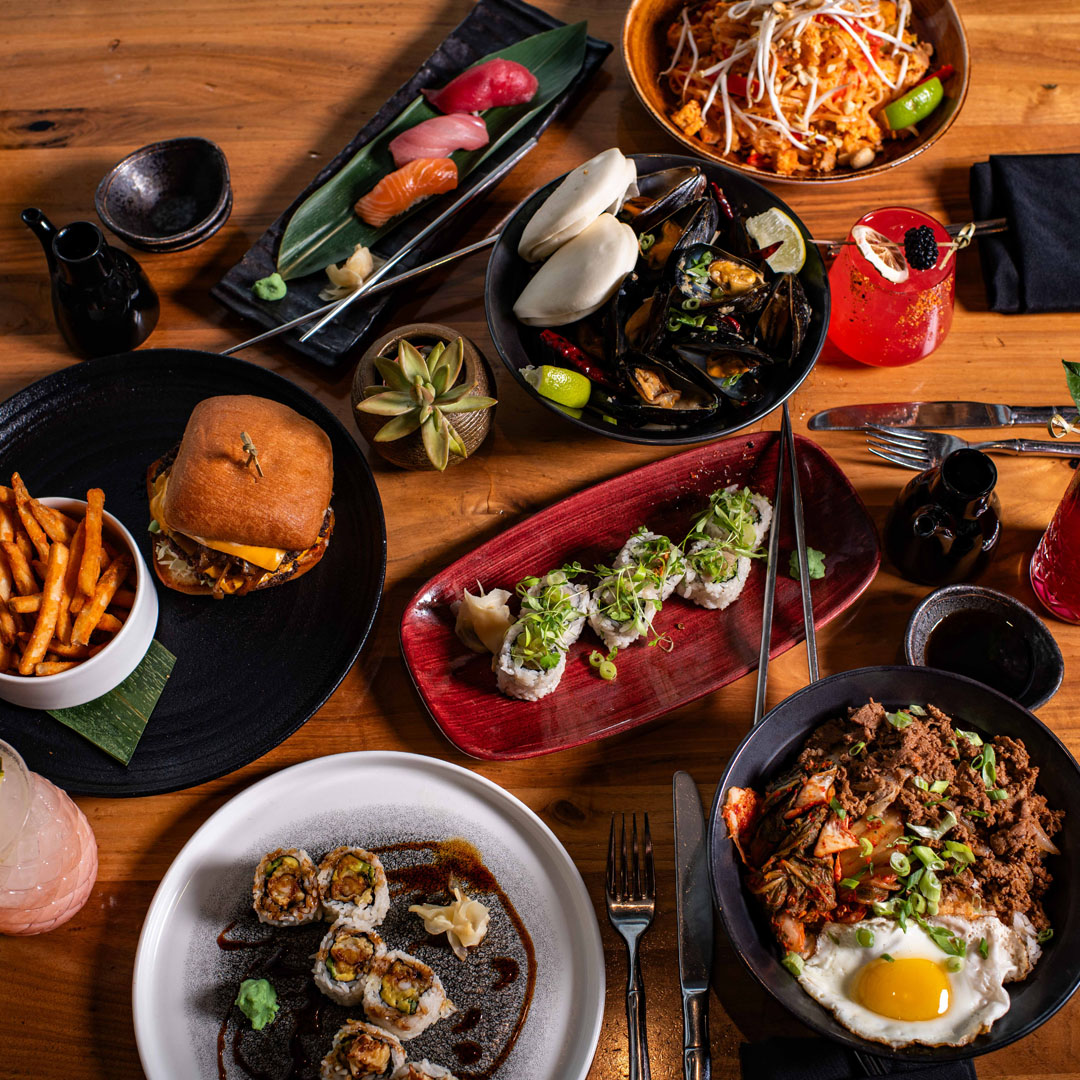 A dining room table inside Orion's Roof Restaurant filled with plated dishes
