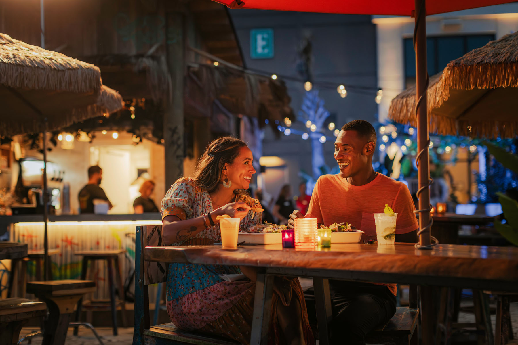 A couple sharing dinner outside at night