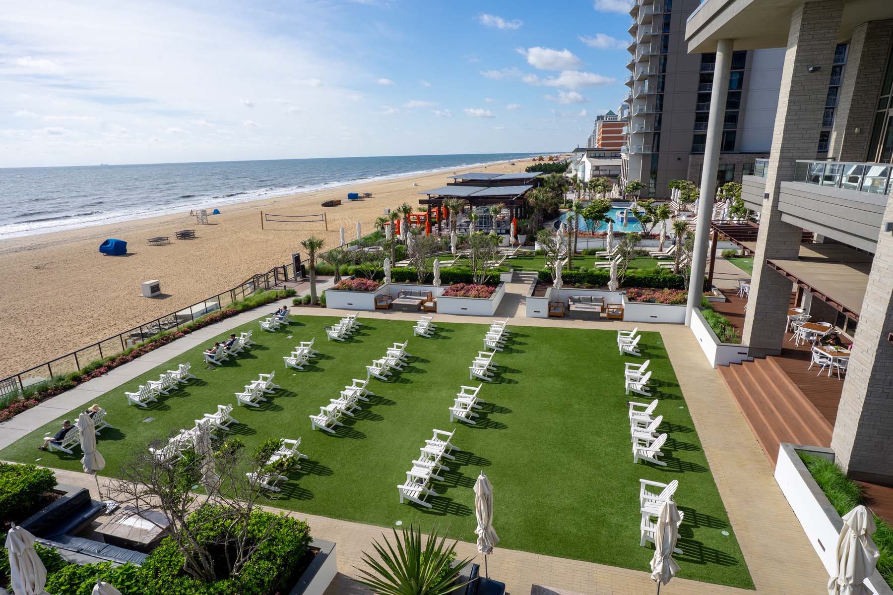 A lawn with chairs alongside the oceanfront