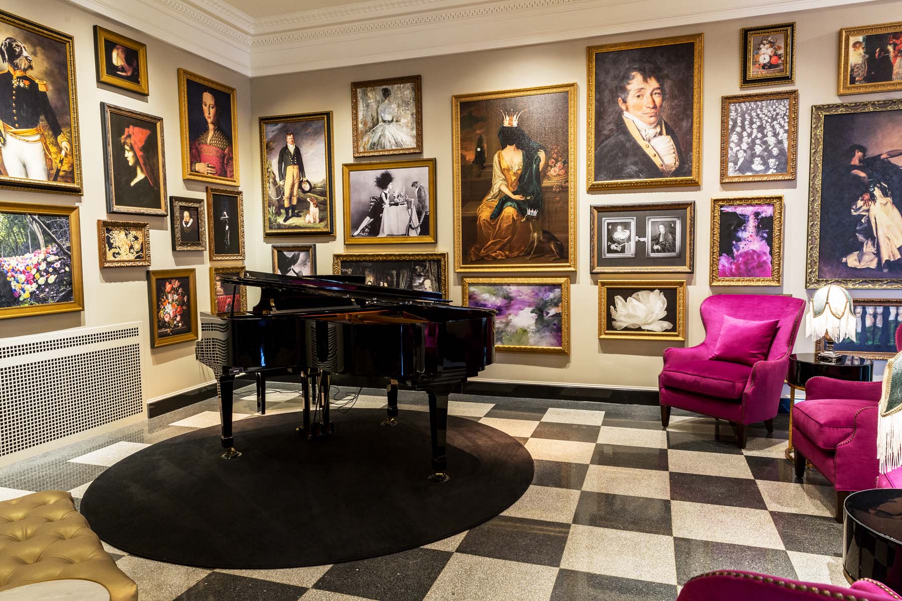 The interior lounge of The Raleigh Room with a piano and artwork