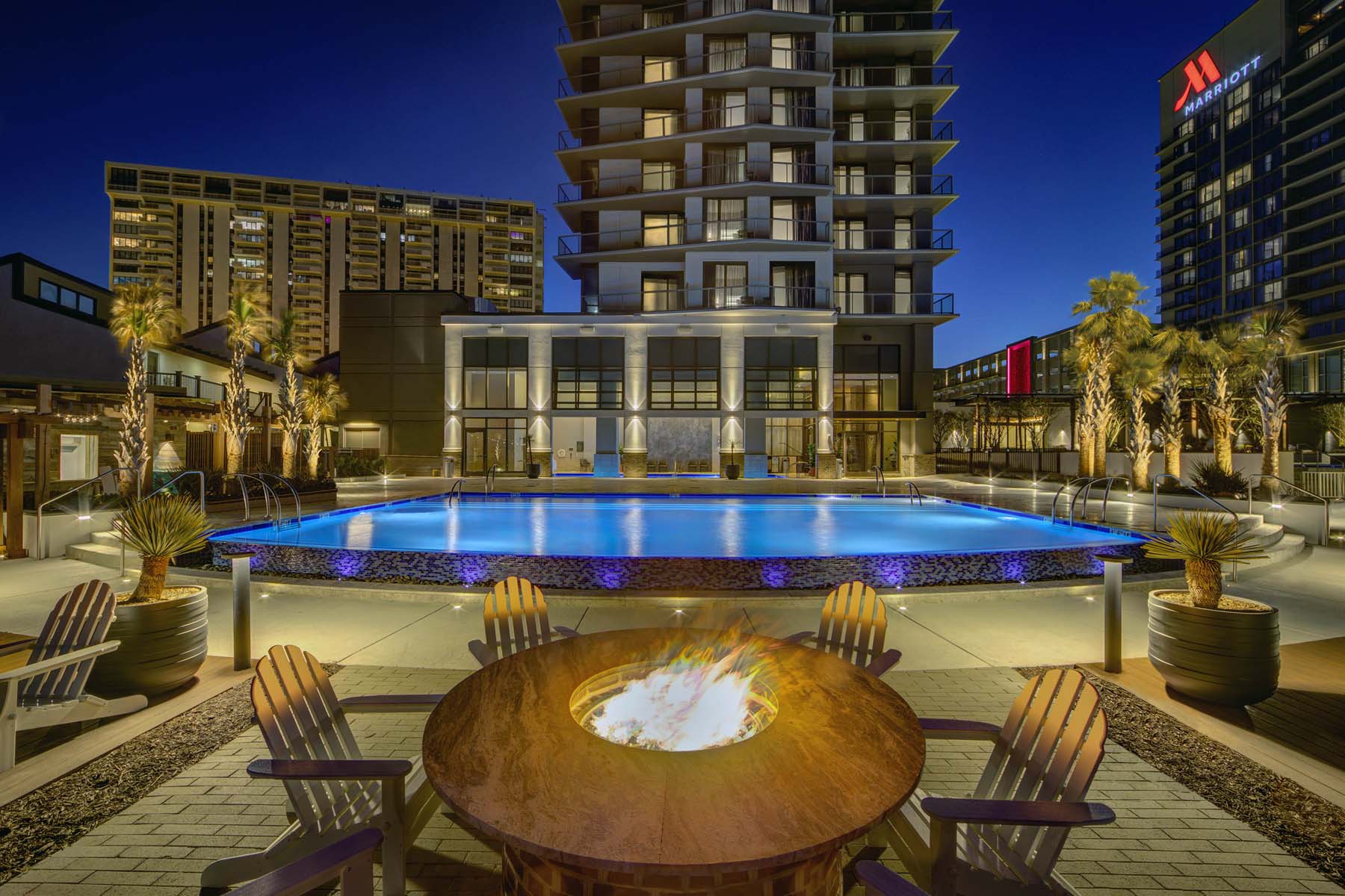An outdoor firepit next to a hotel