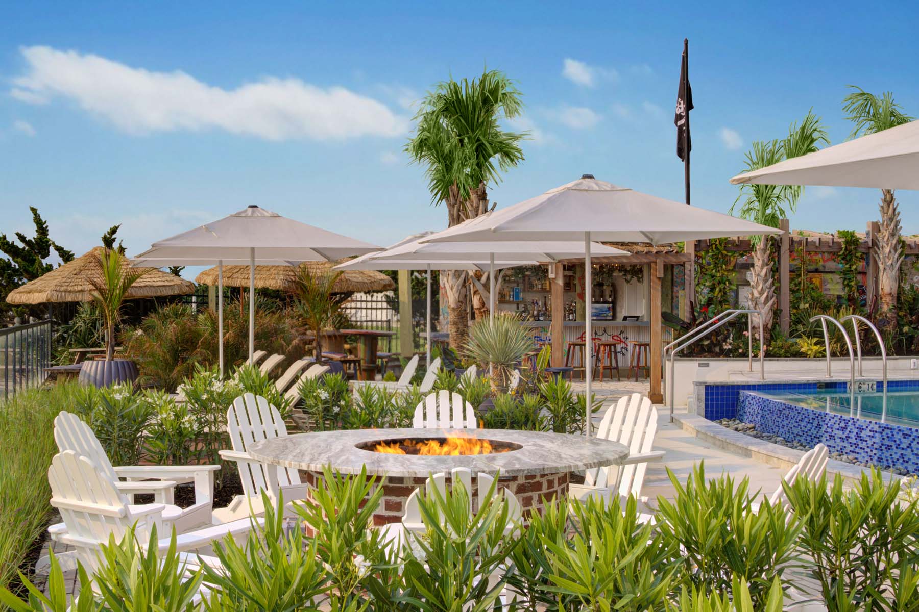 An outdoor firepit next to an outdoor pool
