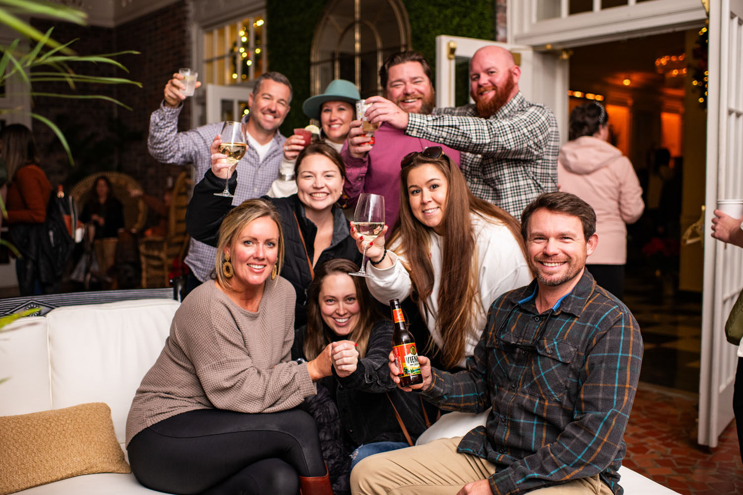A group of friends enjoying drinks inside a hotel lobby during the holidays