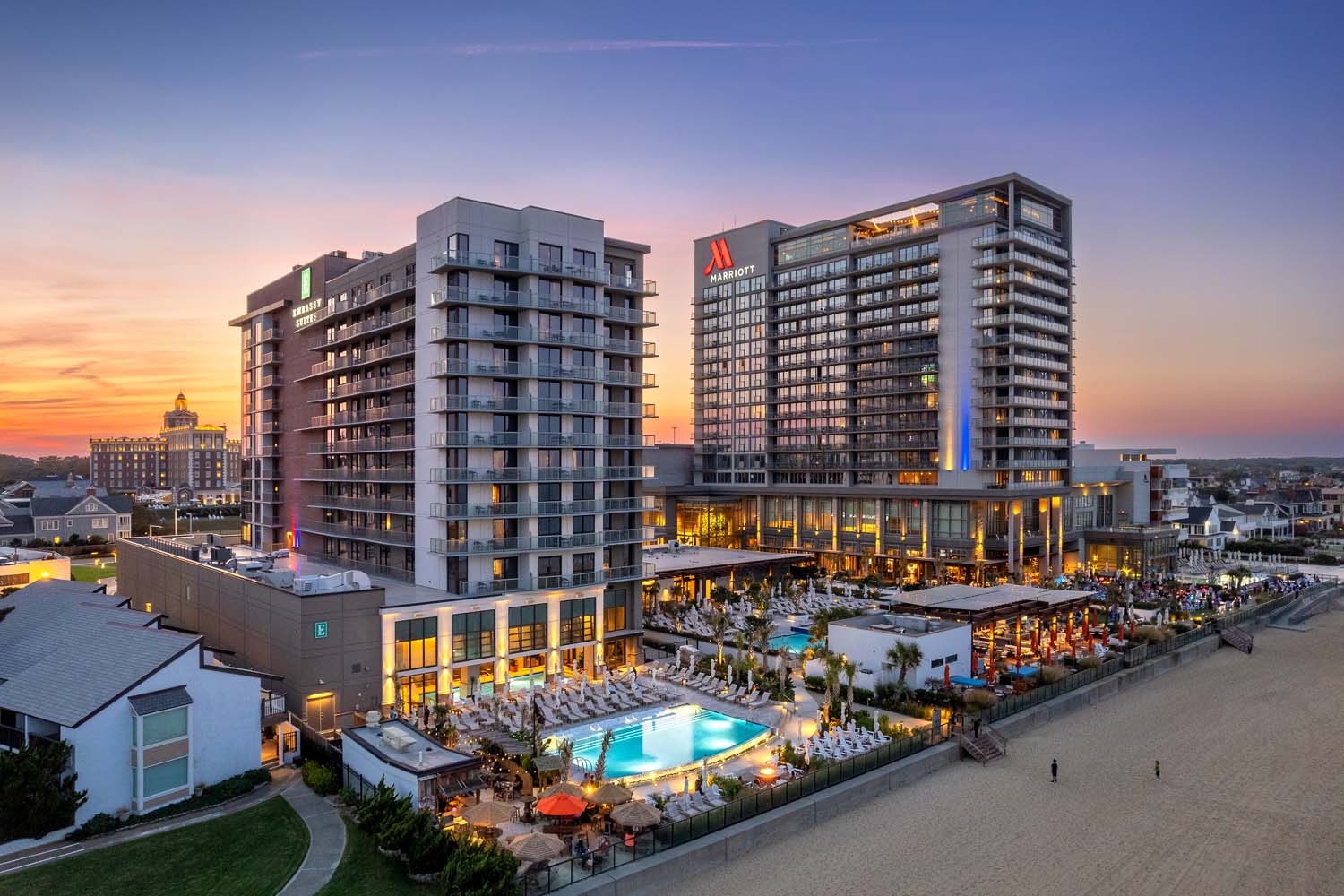 An aerial view at dusk of the three oceanfront hotels at the Cavalier Resort Virginia Beach