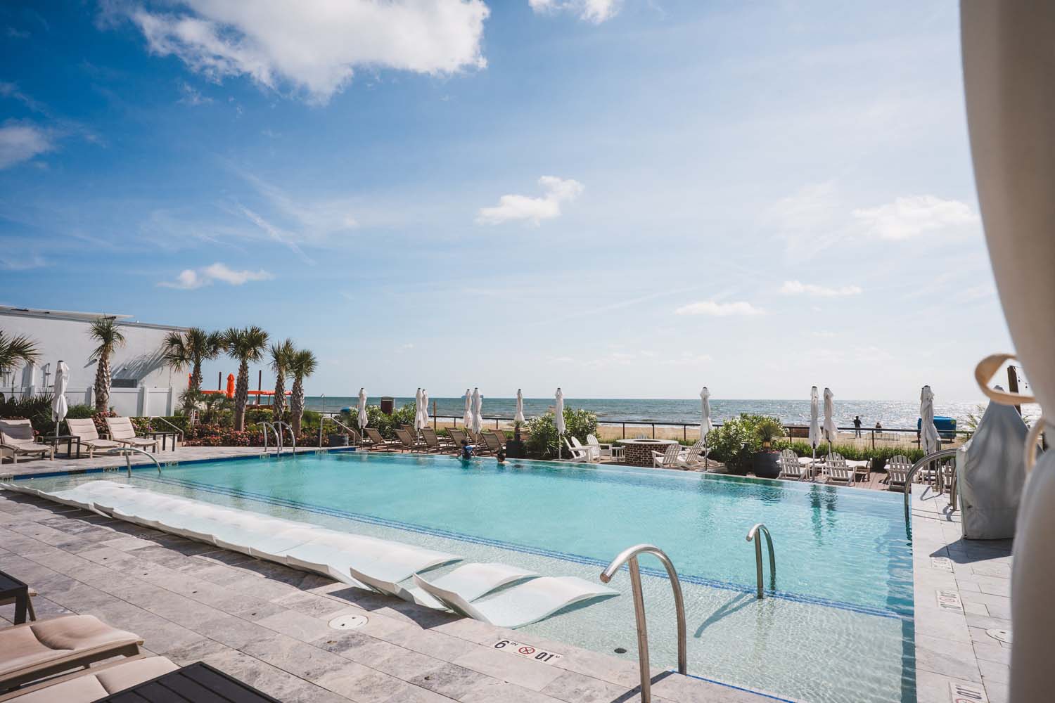 The exterior outdoor pool at the Embassy Suites hotel at the Cavalier Resort