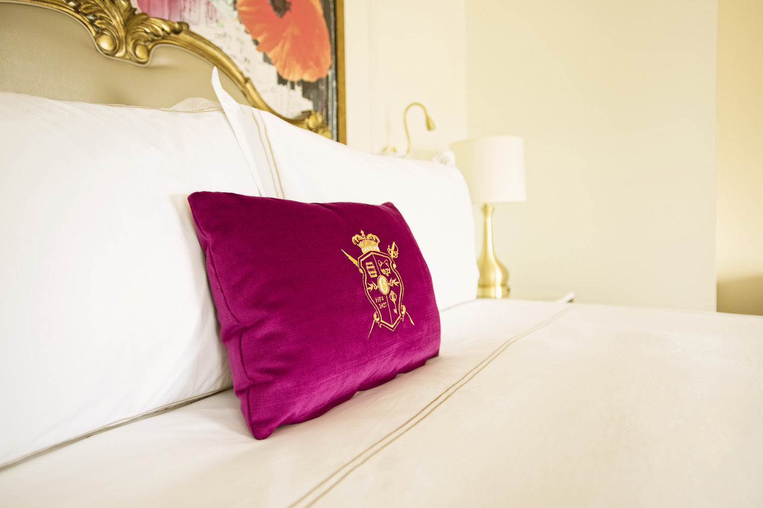 A pillow on a bed inside a guest room at The Historic Cavalier Hotel