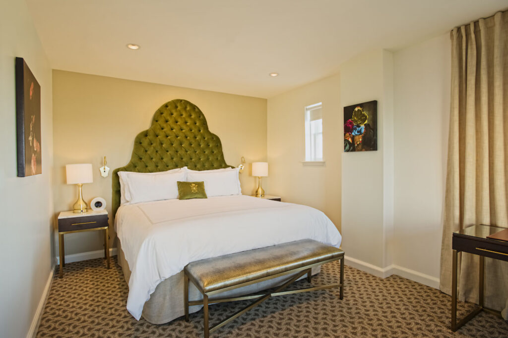 A one bedroom suite with a king bed inside The Historic Cavalier Hotel