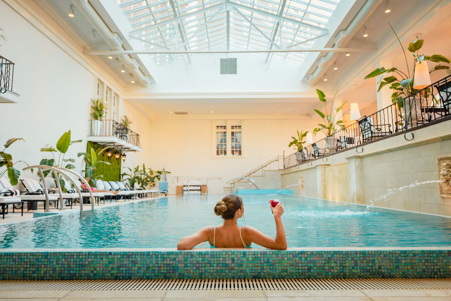 A woman enjoying the indoor pool at The Historic Cavalier Hotel